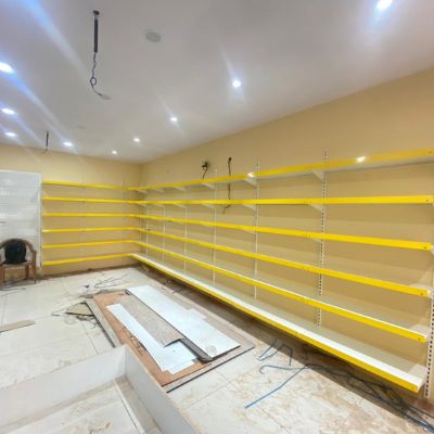 Wall Channel Rack white shelves and yellow endcap