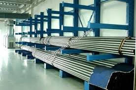 A Landscape Picture of a warehouse Blue Cantilever Racks With Heavy Industrial Grey Color Pipes on first 2 levels.