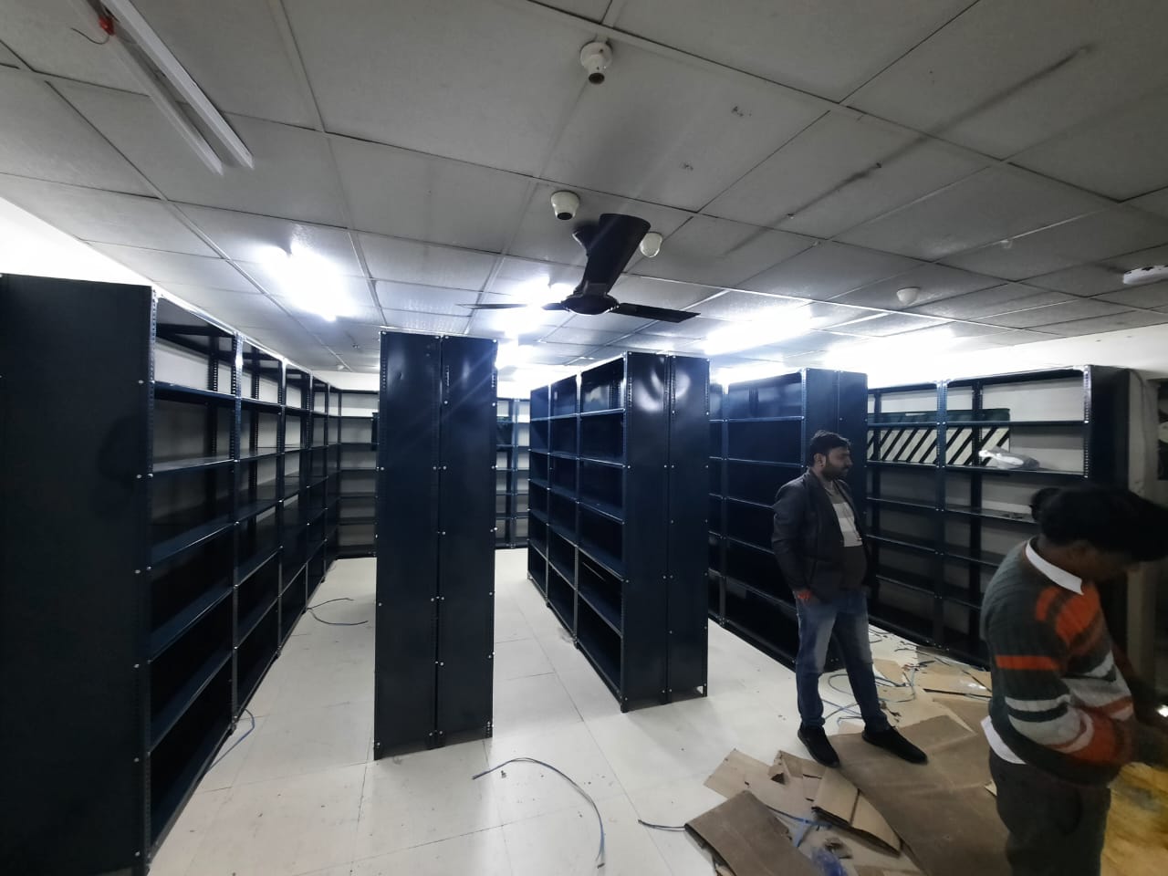 Slotted angle racks for shop in dark grey color used in a supermarket to keep daily house hold items in the slotted angle racks