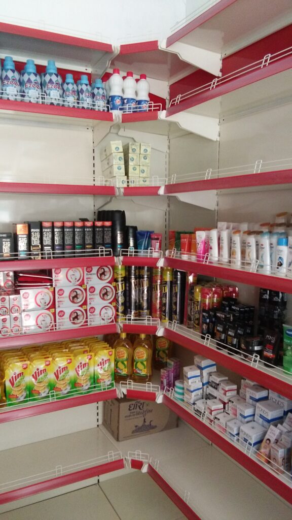 Rack in Himachal Pradesh showing a corner of the store, with shelves stocked with a mix of household items, personal care products, and beverages. The shelves are arranged in a way that maximizes the available space, creating a well-organized and efficient layout.